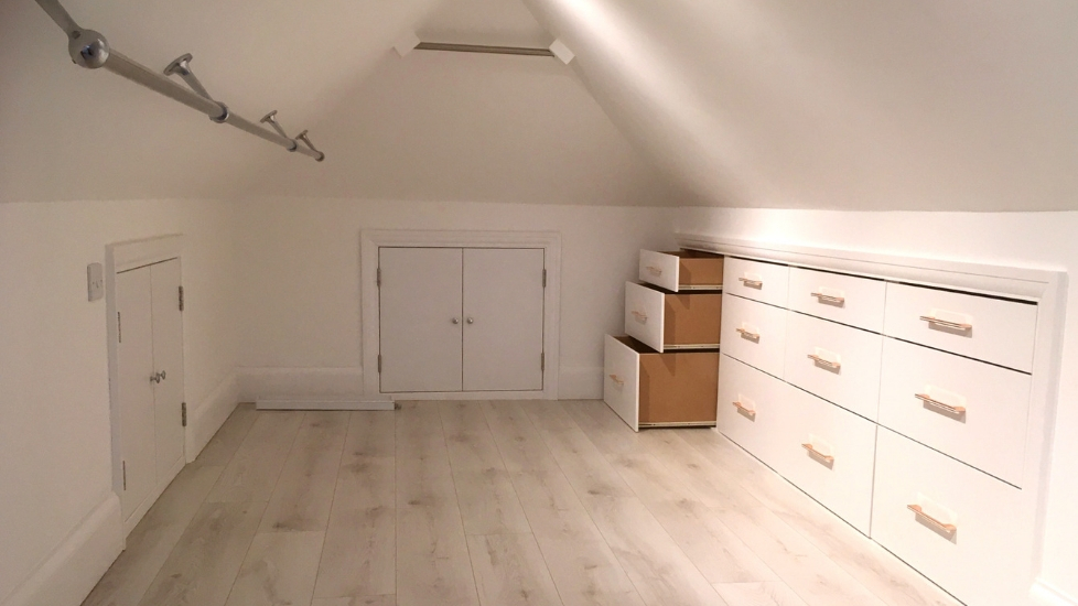 Loft conversion with cupboards, hanging rail and drawers