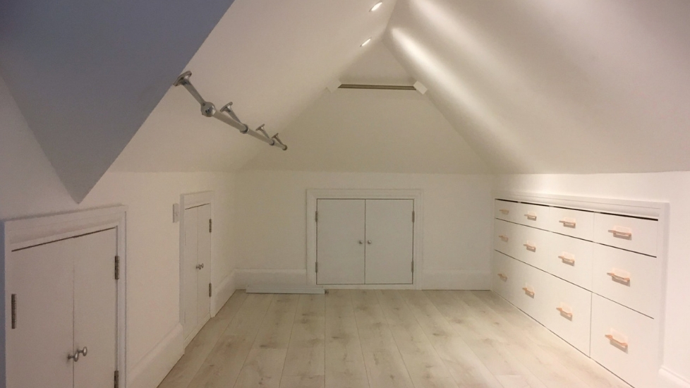 Loft conversion with cupboards, hanging rail and drawers